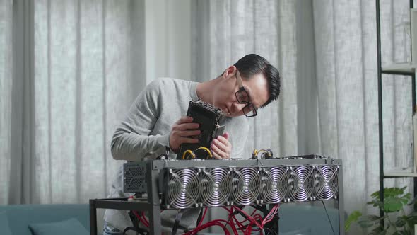 Asian Man Wearing Glasses Build The Mining Rig For Mining Cryptocurrency