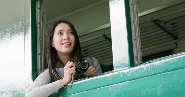 Woman taking photo on camera inside the train