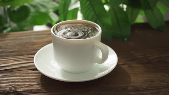 Hot Coffee in White Cup on Wood Background