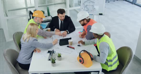 Team of Engineers and their Bearded Boss which Brainstorming Together