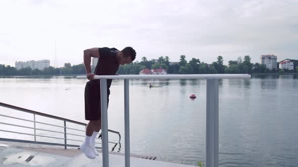 Side View of African Man Doing Triceps Dip Exercise