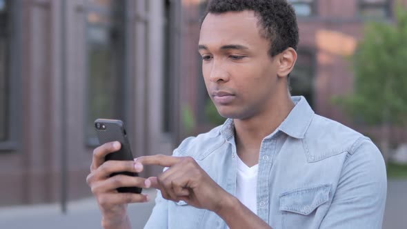 Outdoor African Man Using Smartphone