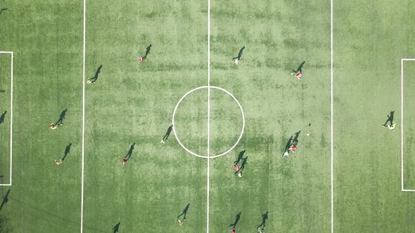 Aerial View of Soccer Players Playing Football on Green Sports Stadium