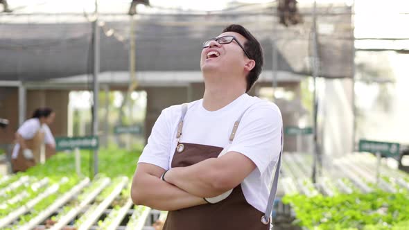 Happy owner Asian man farmer standing in a hydroponics farm