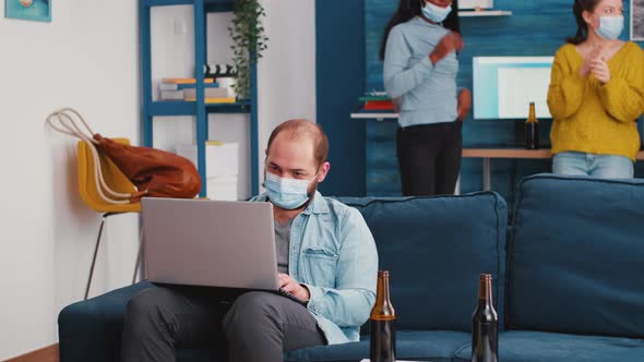 Multiracial Friends Browsing Using Laptop Keeping Social Distancing