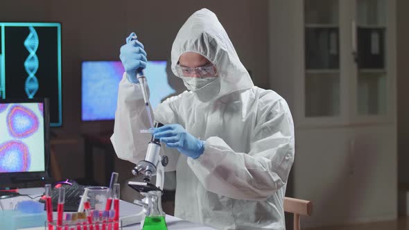 Doctor In Protective Suit Is Doing A Science Experiments And Developing Vaccine In A Modern Lab