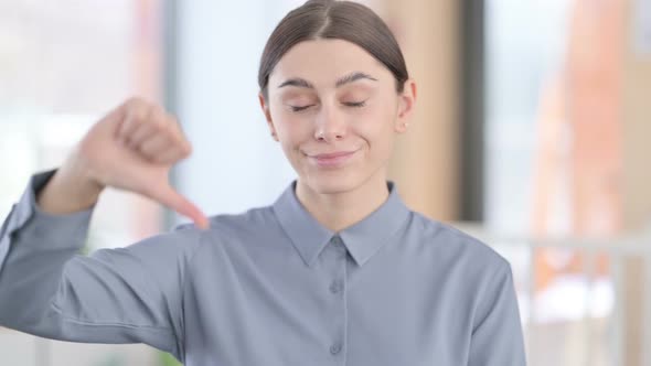 Portrait of Thumbs Down Gesture By Young Woman