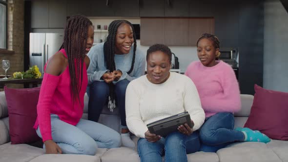 Cheerful Family with Three Teenage Girls Making Video Call with Tablet Pc