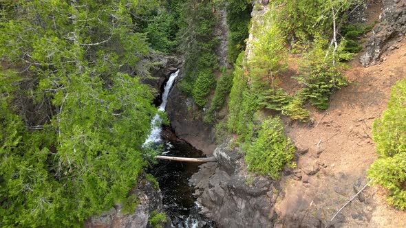 nice waterfall in the middle of threes in a forest up north, caribou falls in Minnesota