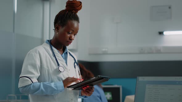 Medic Looking at Tablet Screen for Healthcare System