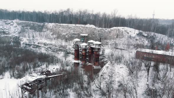 Aerial Footage of Old Machines and Piping Equipment in Liban Quarry  Light Snowfall