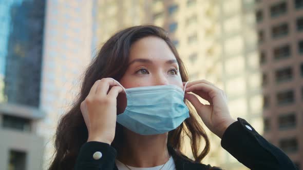 Woman Using Medical Mask Outdoors Closeup