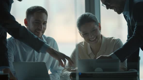 Smiling team of professionals in a meeting while discussing new projects in office