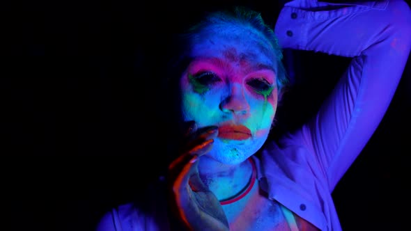 Lady with Fluorescent Makeup Medium Portrait in UV Lights in Darkness