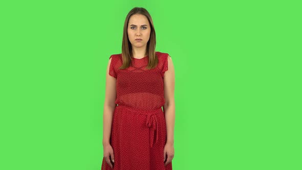 Tender Girl in Red Dress Is Waving Hand and Showing Gesture Come Here. Green Screen