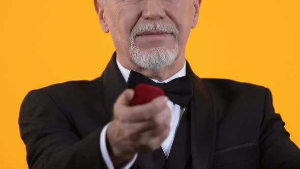 Mature Man in Suit Presenting Ring in Gift Box, Making Proposal, Anniversary