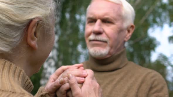 Caring Wife Tenderly Hugging Husbands Hands, Support and Devotion, Close-Up