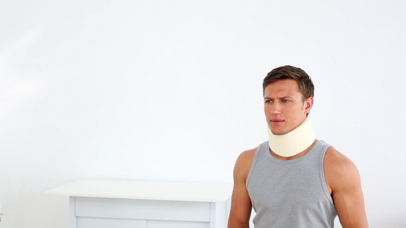 Sportsman In Neck Brace Talking To Doctor