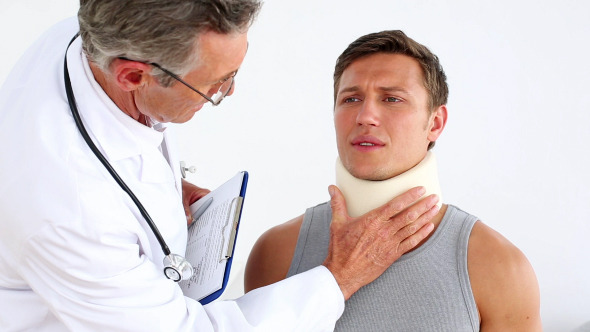 Doctor Checking Sportsman In Neck Brace