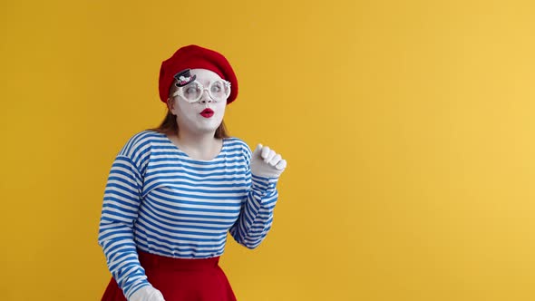 Concept of Gossip a Female Mime Bends Down and Puts Her Hand to Her Ear Eavesdropping on Someone