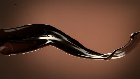 Super Slow Motion Shot of Waving Chocolate Splash on Brown Gradient Background at 1000 Fps
