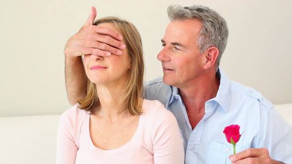 Husband Surprising His Wife With A Pink Rose