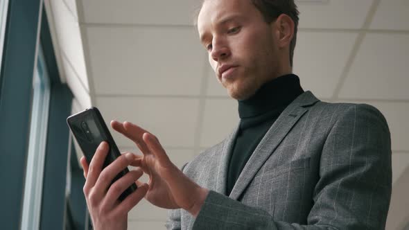 Handsome startup businessman using mobile Phone.