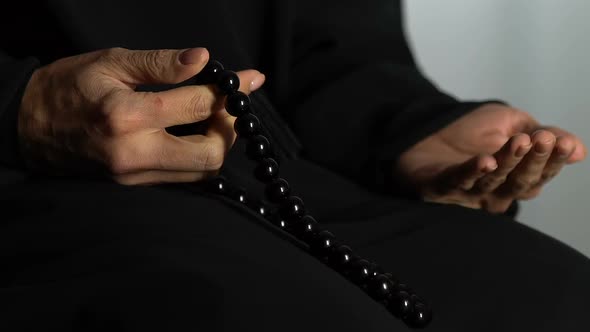 Hands of Woman in Hijab Counting Islamic Beads and Praying in Mosque, Religion