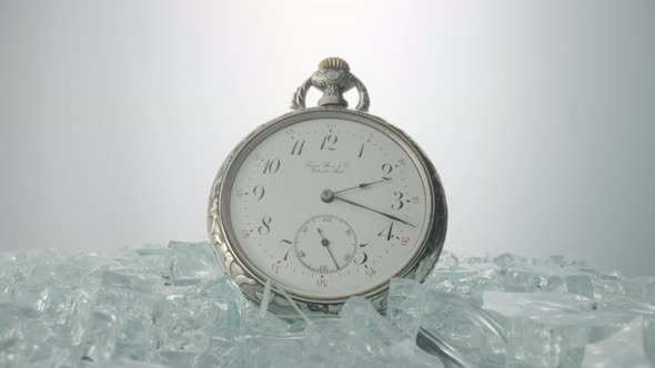 Antique Silver Pocket Watch Among Shiny Crystals or Sparkling Glass Splinters
