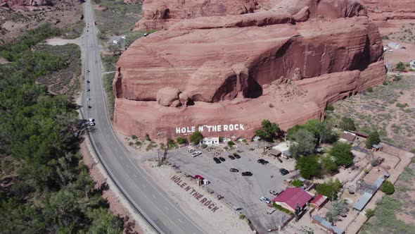 Hole In The Rock Sign On Rock Formation Mountain In Utah Next To Highway.