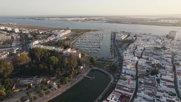 Aerial rotation Ayamonte City and marina landscape with Portugal as background