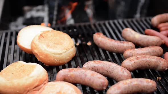 Man Grilling Different Sausages