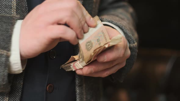 Mafia Gangster in Plaid Suit Gets His Loot in Form of Old Money From Suitcase of Brown Leather