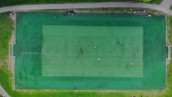 Aerial View of Men Playing Football on a Public City Soccer Field