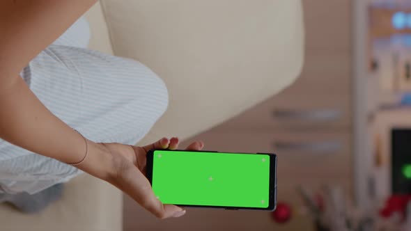 Vertical Video Woman Vertically Holding Smartphone with Green Screen