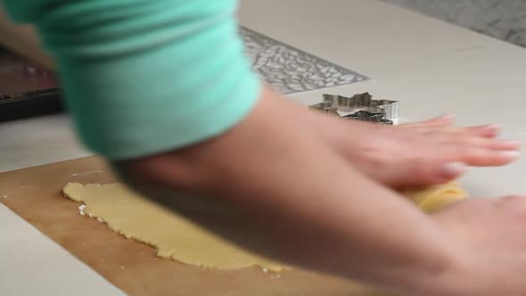 A Woman Rolls Out The Biscuit Dough With A Rolling Pin.