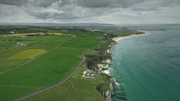 Irish Countryside Cliff Coast Aerial Panoramic Shot Green Fields Meadows and Ocean Bay Cloudy Sky