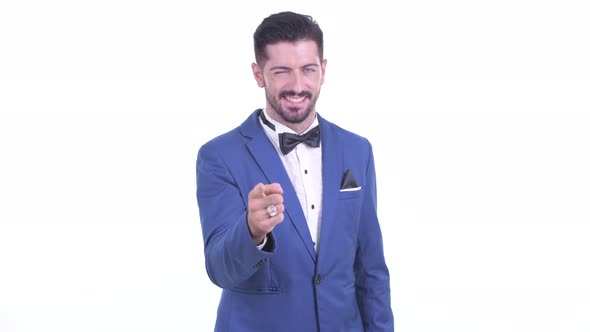 Happy Young Handsome Bearded Businessman Pointing at Camera