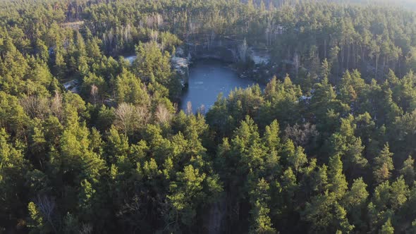 Drone Shot of Abandoned Submerged Quarry in Forest