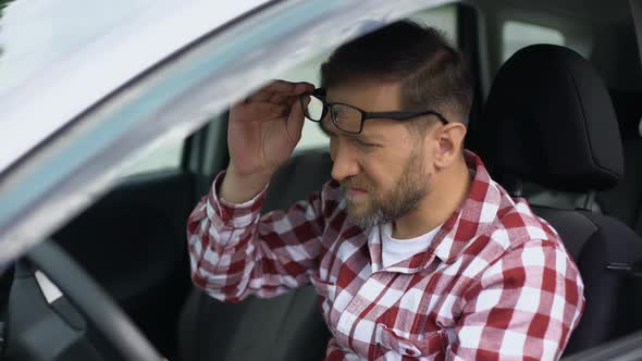 Overworked Car Driver Taking Eyeglasses Off