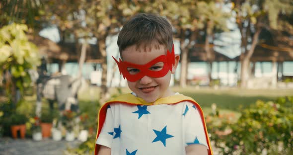 Cute Happy Baby Boy in the Superhero Costume Kid Plays Superhero Child Dressed in a Red and Yellow