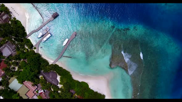 Aerial flying over nature of exotic tourist beach trip by blue ocean and white sandy background of a