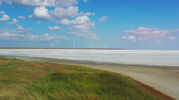 Landscape View on the Wind Turbines in the Distance and White Sand 