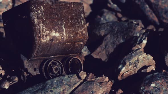 Abandoned Rusty Mine Cart on Rocks alt