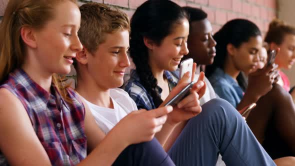 Group of school friends using mobile phone 4k