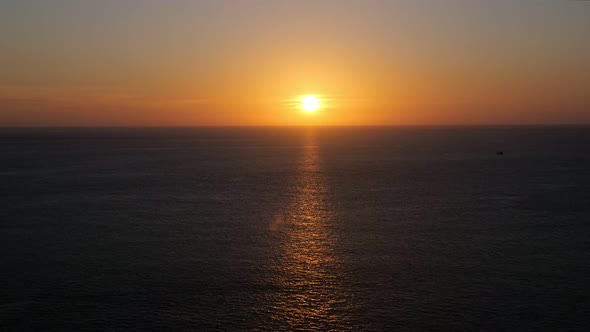 Sunset Leaves Golden Path Sparkling on Calm Ocean Surface