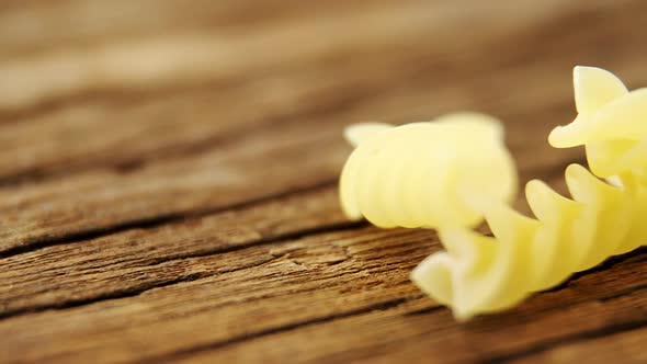 Gemelli pasta on wooden table