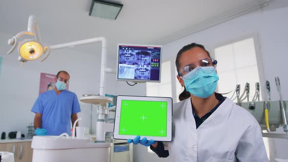 Patient Pov of Dentist Analisyng Xray Using Tablet with Green Screen