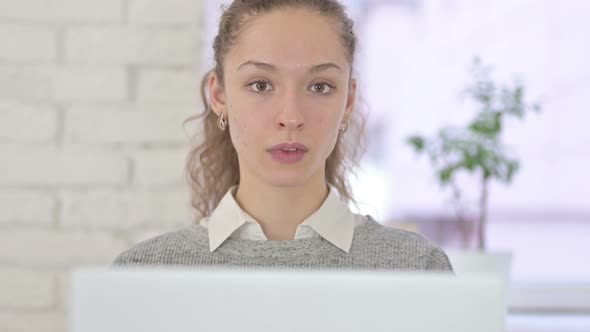 Attractive Young Latin Woman Saying No By Finger in Office