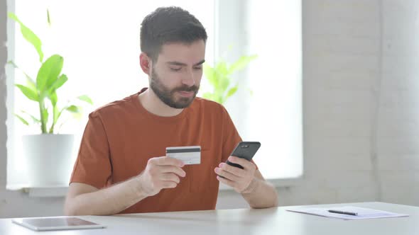 Young Man Shopping Online on Smartphone Banking